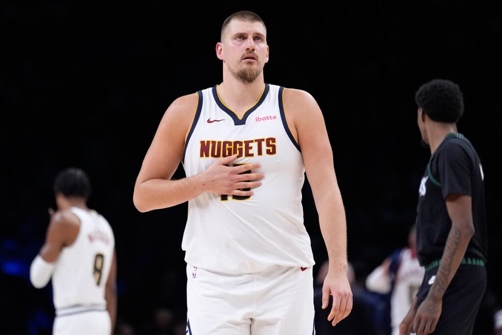 Denver Nuggets center Nikola Jokic walks across the court during the first half of an NBA basketball game against the Minnesota Timberwolves, Monday, Oct. 27, 2025, in Minneapolis. (AP Photo/Abbie Parr)