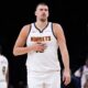 Denver Nuggets center Nikola Jokic walks across the court during the first half of an NBA basketball game against the Minnesota Timberwolves, Monday, Oct. 27, 2025, in Minneapolis. (AP Photo/Abbie Parr)