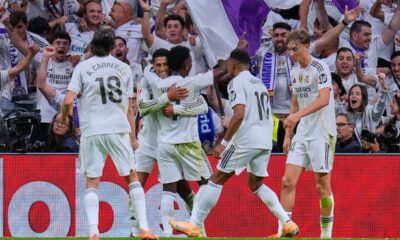 Real Madrid's Jude Bellingham, left, celebrates with teammates after scoring their side's second goal during the Spanish La Liga soccer match between Real Madrid and Barcelona, in Madrid, Sunday, Oct. 26, 2025. (AP Photo/Manu Fernandez)