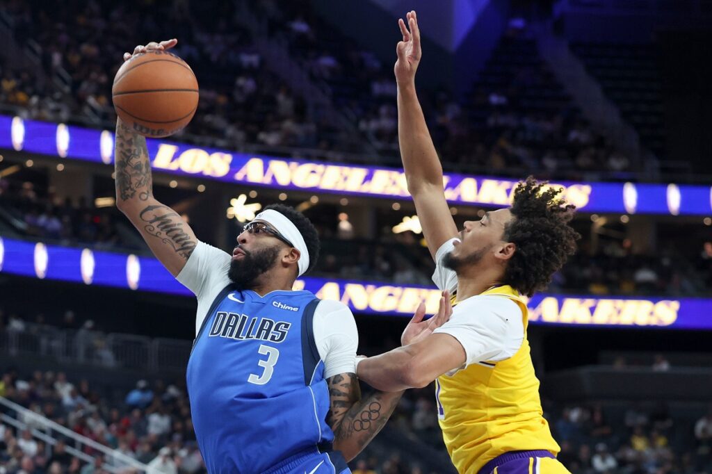 Dallas Mavericks forward Anthony Davis (3) rebounds against Los Angeles Lakers center Jaxson Hayes (11) during the first half of a preseason NBA basketball game Wednesday, Oct. 15, 2025, in Las Vegas. (AP Photo/Ian Maule)