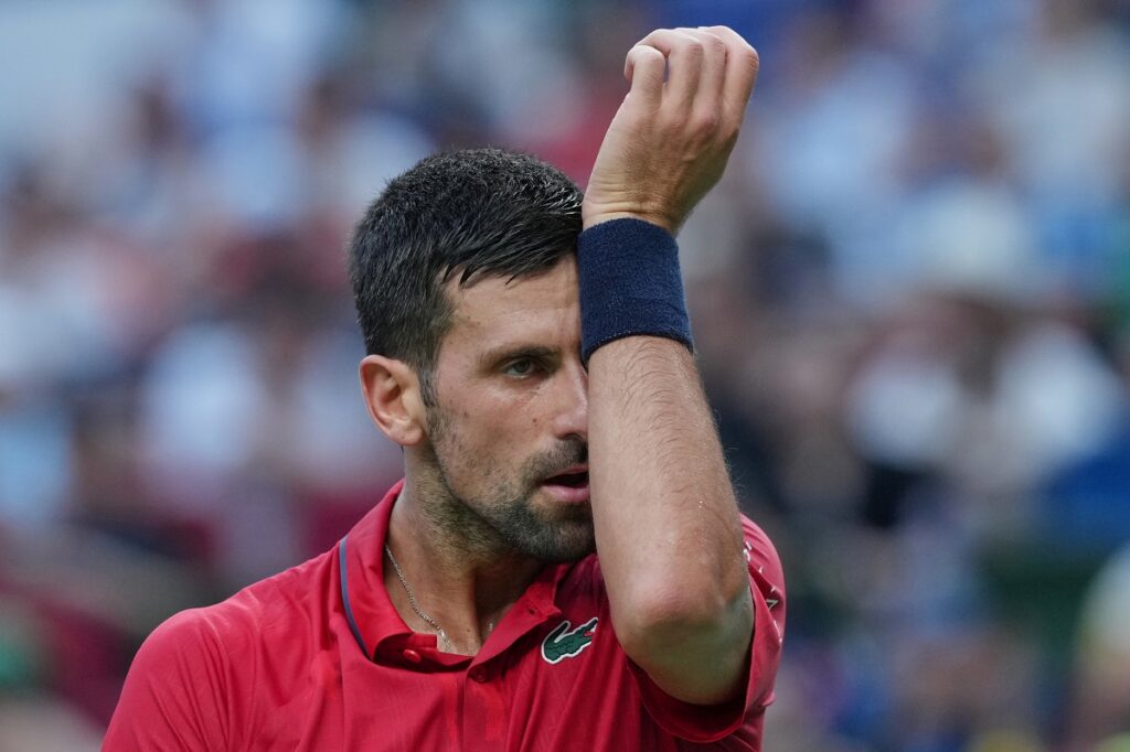 Novak Djokovic of Serbia reacts as he plays with Valentin Vacherot of Monaco during the men's singles semifinal match of the Shanghai Masters tennis tournament at Qizhong Forest Sports City Tennis Center, in Shanghai, China, Saturday, Oct. 11, 2025. (AP Photo/Andy Wong)