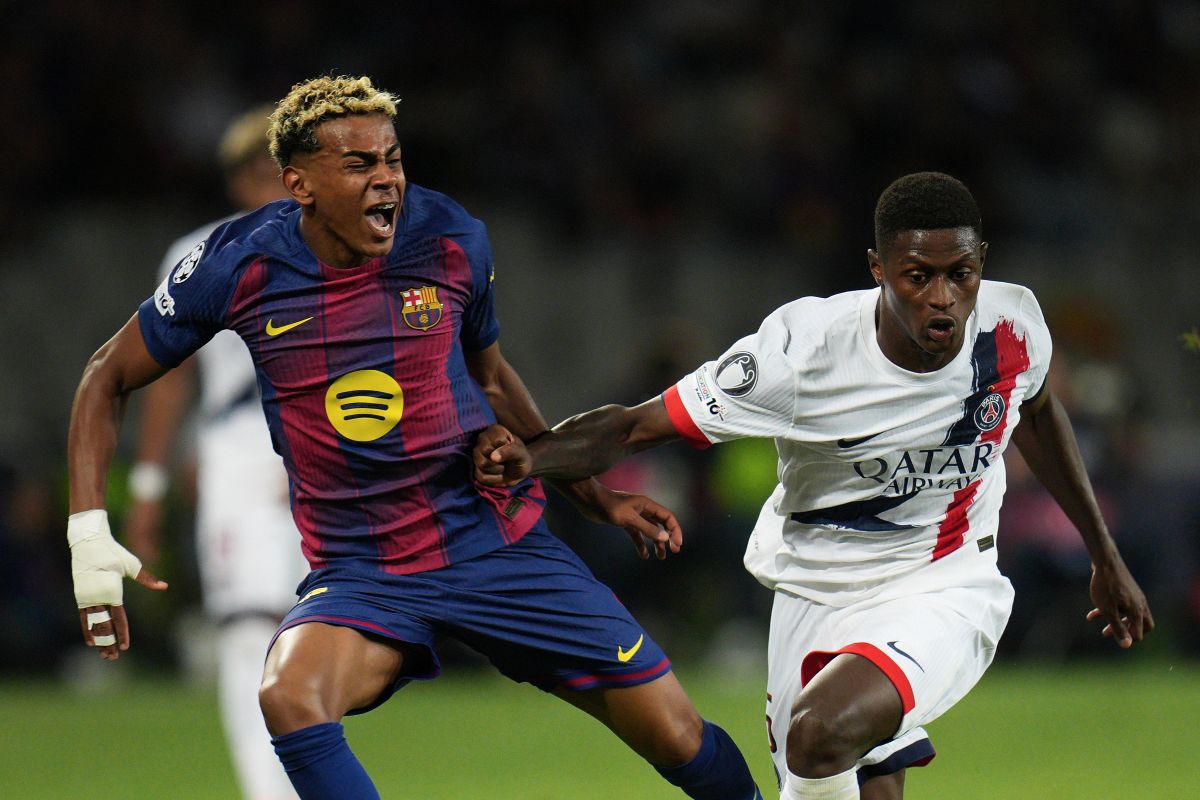 SG's Nuno Mendes fouls Barcelona's Lamine Yamal during the Champions League opening phase soccer match between Barcelona and Paris Saint-Germain at the Lluis Companys Olympic Stadium in Barcelona, Spain, Wednesday, Oct.1, 2025. (AP Photo/Emilio Morenatti)