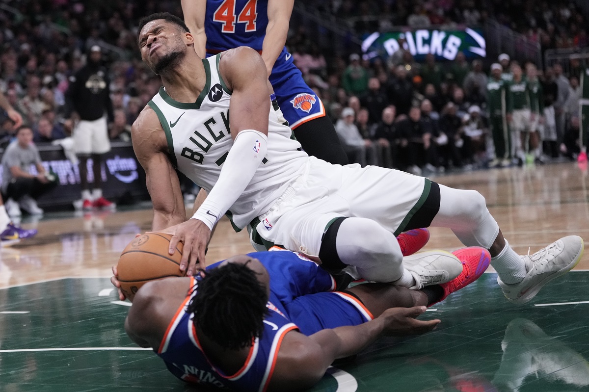 Milwaukee Bucks' Giannis Antetokounmpo is fouled by New York Knicks' OG Anunoby during the second half of an NBA basketball game Tuesday, Oct. 28, 2025, in Milwaukee. (AP Photo/Morry Gash)