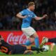 Napoli's Kevin De Bruyne and Inter Milan's Hakan Calhanoglu, bottom, fight for the ball during the Italian Serie A soccer match between Napoli and Inter Milan, in Naples, Italy, Saturday, Oct. 25, 2025. (Alessandro Garofalo/LaPresse via AP)