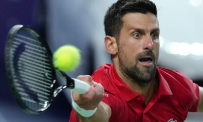 Novak Djokovic of Serbia returns a backhand shot from Zizou Bergs of Belgium during the men's singles quarterfinal match of the Shanghai Masters tennis tournament at Qizhong Forest Sports City Tennis Center, in Shanghai, China, Thursday, Oct. 9, 2025. (AP Photo/Andy Wong)