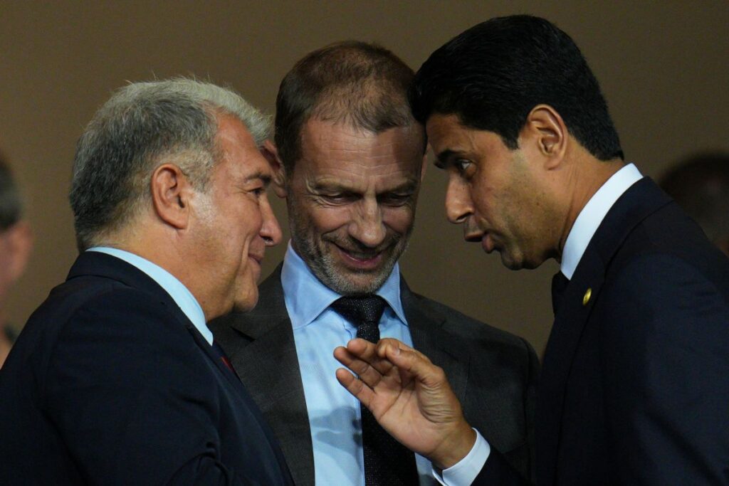 UEFA President Aleksander Ceferin, center, FC Barcelona president Joan Laporta, left, and PSG president Nasser Al-Khelaifi speak before the Champions League opening phase soccer match between Barcelona and Paris Saint-Germain at the Lluis Companys Olympic Stadium in Barcelona, Spain, Wednesday, Oct.1, 2025. (AP Photo/Emilio Morenatti)