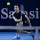 Serbia's Miomir Kecmanovic returns a ball to Switzerland's Stan Wawrinka during their first round match at the Swiss Indoors tennis tournament at the St. Jakobshalle in Basel, Switzerland, Tuesday, Oct. 21, 2025. (Georgios Kefalas/Keystone via AP)