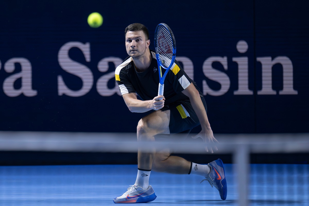 Serbia's Miomir Kecmanovic returns a ball to Switzerland's Stan Wawrinka during their first round match at the Swiss Indoors tennis tournament at the St. Jakobshalle in Basel, Switzerland, Tuesday, Oct. 21, 2025. (Georgios Kefalas/Keystone via AP)