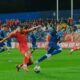 Montenegro's Milutin Osmajic, front, kicks the ball during an international friendly soccer match between Montenegro and Liechtenstein at the City Stadium, in Podgorica, Montenegro, Monday, Oct. 13, 2025. (AP Photo/Risto Bozovic)