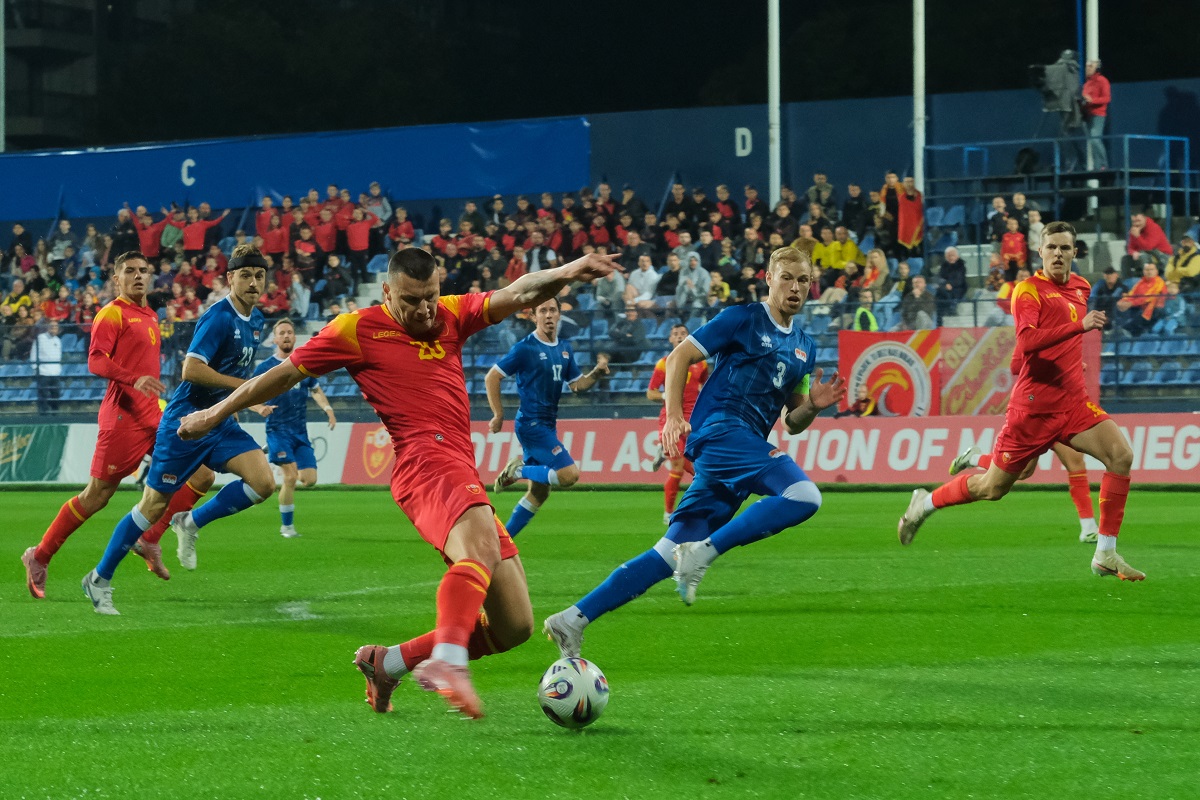 Montenegro's Milutin Osmajic, front, kicks the ball during an international friendly soccer match between Montenegro and Liechtenstein at the City Stadium, in Podgorica, Montenegro, Monday, Oct. 13, 2025. (AP Photo/Risto Bozovic)