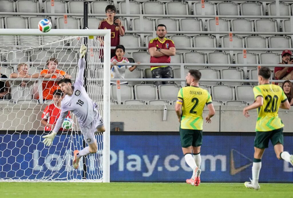 Australia's Patrick Beach goalkeeper (18) dives for a deflected shot on goal by Venezuela during the second half of an international friendly soccer match, Friday, Nov. 14, 2025, in Houston. (AP Photo/Karen Warren)