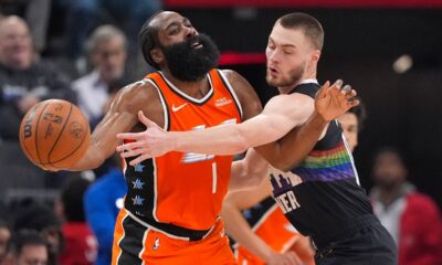 Denver Nuggets guard Christian Braun, right, reaches in on Los Angeles Clippers guard James Harden during the first half of an NBA basketball game Wednesday, Nov. 12, 2025, in Inglewood, Calif. (AP Photo/Mark J. Terrill)