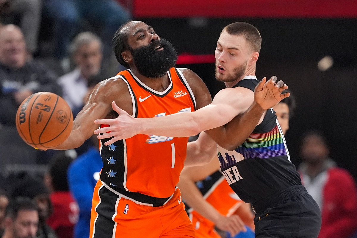 Denver Nuggets guard Christian Braun, right, reaches in on Los Angeles Clippers guard James Harden during the first half of an NBA basketball game Wednesday, Nov. 12, 2025, in Inglewood, Calif. (AP Photo/Mark J. Terrill)