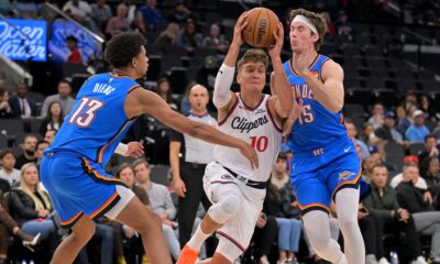 Los Angeles Clippers guard Bogdan Bogdanovic (10) drives past Oklahoma City Thunder forward Ousmane Dieng (13) and Thunder center Branden Carlson during the second half of an NBA basketball game Tuesday, Nov. 4, 2025, in Los Angeles. (AP Photo/Jayne Kamin-Oncea)