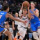 Los Angeles Clippers guard Bogdan Bogdanovic (10) drives past Oklahoma City Thunder forward Ousmane Dieng (13) and Thunder center Branden Carlson during the second half of an NBA basketball game Tuesday, Nov. 4, 2025, in Los Angeles. (AP Photo/Jayne Kamin-Oncea)