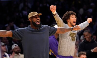 Los Angeles Lakers' LeBron James, left, and Jaxson Hayes gesture during the second half of an NBA basketball game against the San Antonio Spurs, Wednesday, Nov. 5, 2025, in Los Angeles. (AP Photo/Mark J. Terrill)
