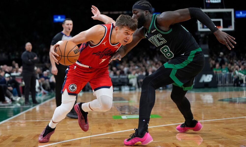 Los Angeles Clippers Bogdan Bogdanovic drives against Boston Celtics center Neemias Queta during the first half of an NBA basketball game, Sunday, Nov. 16, 2025, in Boston. (AP Photo/Robert F. Bukaty)