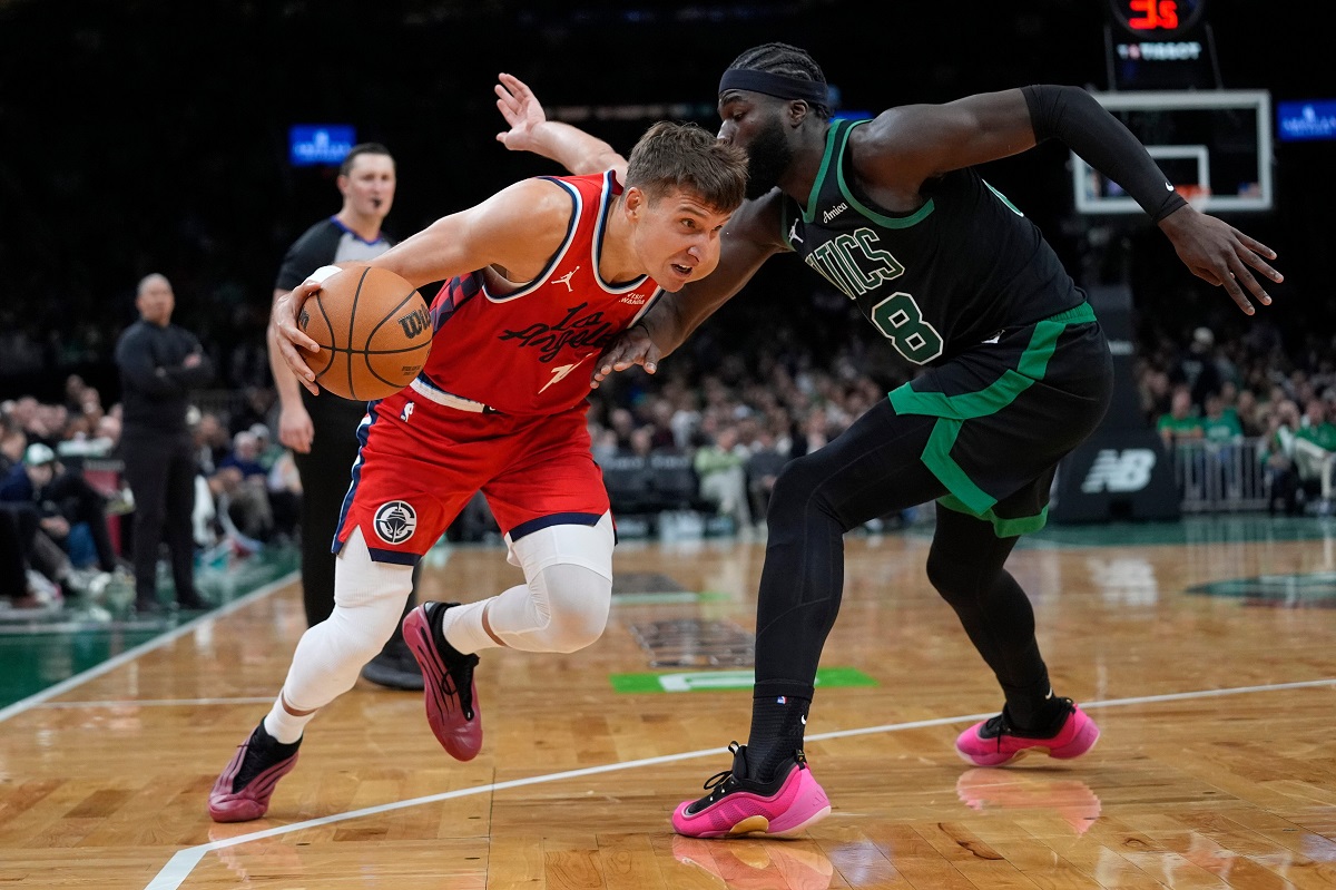 Los Angeles Clippers Bogdan Bogdanovic drives against Boston Celtics center Neemias Queta during the first half of an NBA basketball game, Sunday, Nov. 16, 2025, in Boston. (AP Photo/Robert F. Bukaty)