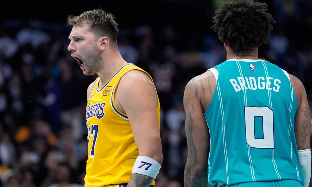 Los Angeles Lakers guard Luka Doncic celebrates after scoring as Charlotte Hornets forward Miles Bridges looks on during the second half of an NBA basketball game Monday, Nov. 10, 2025, in Charlotte, N.C. (AP Photo/Chris Carlson)