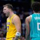 Los Angeles Lakers guard Luka Doncic celebrates after scoring as Charlotte Hornets forward Miles Bridges looks on during the second half of an NBA basketball game Monday, Nov. 10, 2025, in Charlotte, N.C. (AP Photo/Chris Carlson)