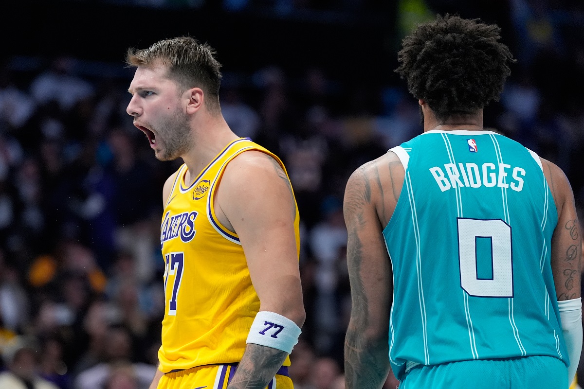 Los Angeles Lakers guard Luka Doncic celebrates after scoring as Charlotte Hornets forward Miles Bridges looks on during the second half of an NBA basketball game Monday, Nov. 10, 2025, in Charlotte, N.C. (AP Photo/Chris Carlson)