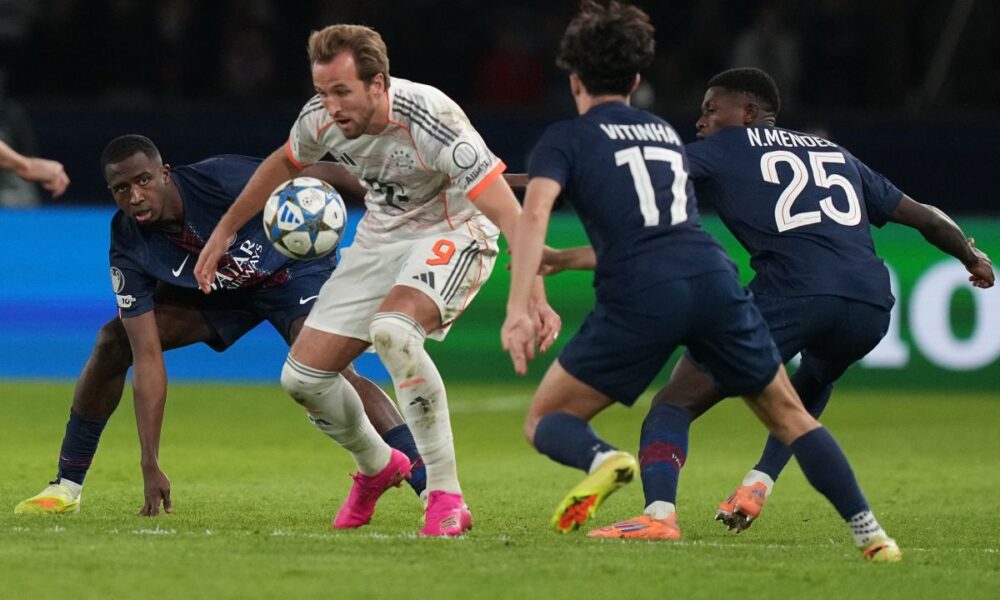 PSG's Willian Pacho watches Bayern's Harry Kane during the Champions League opening phase soccer match between Paris Saint-Germain and Bayern Munich in Paris, France, Tuesday, Nov. 4, 2025. (AP Photo/Thibault Camus)