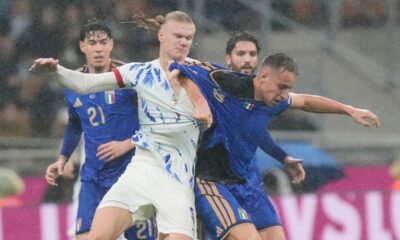 Norway's Erling Haaland, centre left, and Italy's Davide Frattesi, right, challenge for the ball during the 2026 World Cup Group I qualifier soccer match between Italy and Norway in Milan, Italy, Sunday, Nov. 16, 2025. (AP Photo/Luca Bruno)