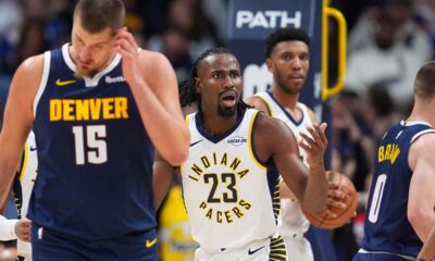 Indiana Pacers forward Aaron Nesmith, center, reacts after being called for a foul on Denver Nuggets center Nikola Jokić, front, as Indiana center Tony Bradley looks on in the second half of an NBA basketball game, Saturday, Nov. 8, 2025, in Denver. (AP Photo/David Zalubowski)