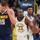 Indiana Pacers forward Aaron Nesmith, center, reacts after being called for a foul on Denver Nuggets center Nikola Jokić, front, as Indiana center Tony Bradley looks on in the second half of an NBA basketball game, Saturday, Nov. 8, 2025, in Denver. (AP Photo/David Zalubowski)