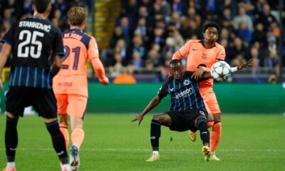 Brugge's Carlos Forbs, second right, fights for the ball with Barcelona's Alejandro Balde, right, during the Champions League opening phase soccer match between Club Brugge and Barcelona in Bruges, Belgium, Wednesday, Nov. 5, 2025. (AP Photo/Geert Vanden Wijngaert)