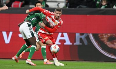 Bremen's Karim Coulibaly, left, and Berlin's Andrej Ilic in action during the Bundesliga soccer match between FC Union Berlin, Matchday 8, at Weserstadion in Bremen, Germany, Friday Oct. 24, 2025. (Carmen Jaspersen/dpa via AP)