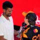 McLaren driver Oscar Piastri of Australia, right, receives the winners trophy from Serbian tennis player Novak Djokovic after the sprint race at the Lusail International Circuit ahead of the Qatar Formula One Grand Prix, in Lusail, Qatar, Saturday, Nov. 29, 2025. (AP Photo/Altaf Qadri)