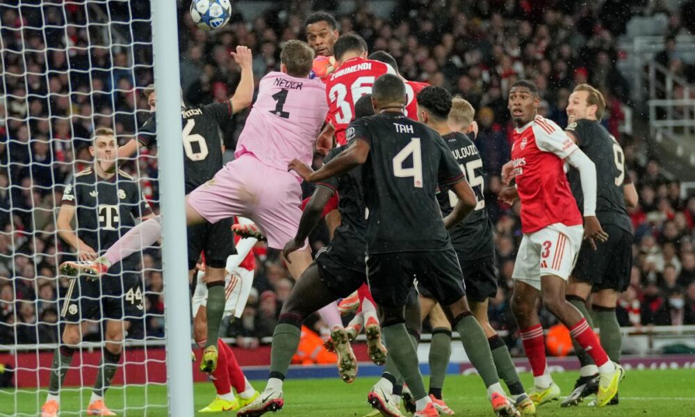 Arsenal's Jurrien Timber, top center, scores the opening goal during the Champions League opening phase soccer match between Arsenal and Bayern Munich in London, Wednesday, Nov. 26, 2025. (AP Photo/Kin Cheung)