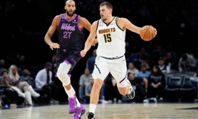 Denver Nuggets center Nikola Jokic (15) works toward the basket as Minnesota Timberwolves center Rudy Gobert (27) defends during the second half of an NBA basketball game, Saturday, Nov. 15, 2025, in Minneapolis. (AP Photo/Abbie Parr)