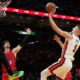Miami Heat forward Nikola Jovic (5) shoots as Portland Trail Blazers forward Deni Avdija (8) defends during the second half of an NBA basketball game, Saturday, Nov. 8, 2025, in Miami. (AP Photo/Lynne Sladky)