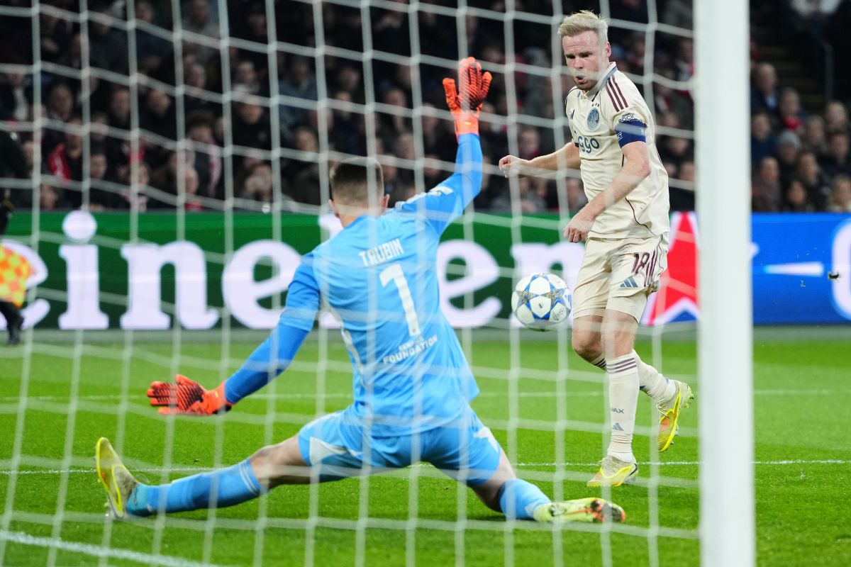 Benfica's goalkeeper Anatoliy Trubin makes a save in front of Ajax's Davy Klaassen during the Champions League opening phase soccer match between Ajax and SL Benfica in Amsterdam, Netherlands, Tuesday, Nov. 25, 2025. (AP Photo/Peter Dejong)