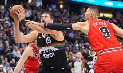 Denver Nuggets center Nikola Jokić (15) drives past Chicago Bulls center Nikola Vučević (9) in the first half of an NBA basketball game Monday, Nov. 17, 2025, in Denver. (AP Photo/David Zalubowski)