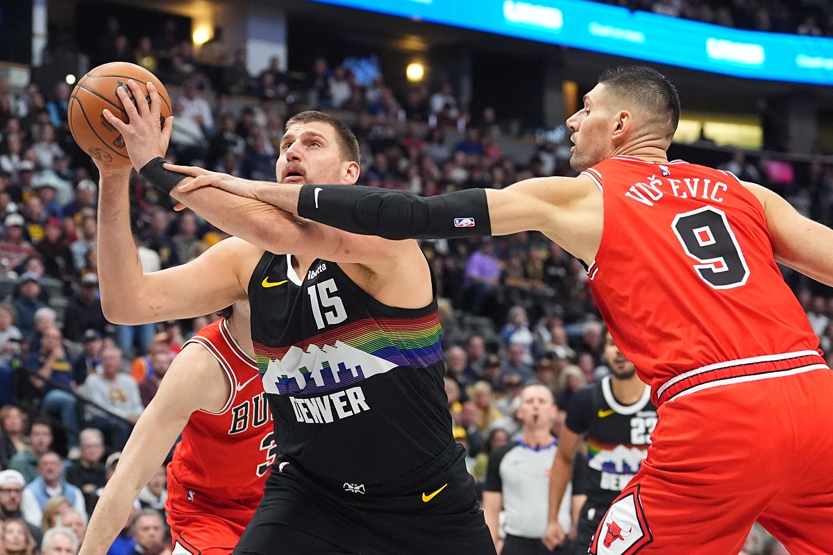 Denver Nuggets center Nikola Jokić (15) drives past Chicago Bulls center Nikola Vučević (9) in the first half of an NBA basketball game Monday, Nov. 17, 2025, in Denver. (AP Photo/David Zalubowski)