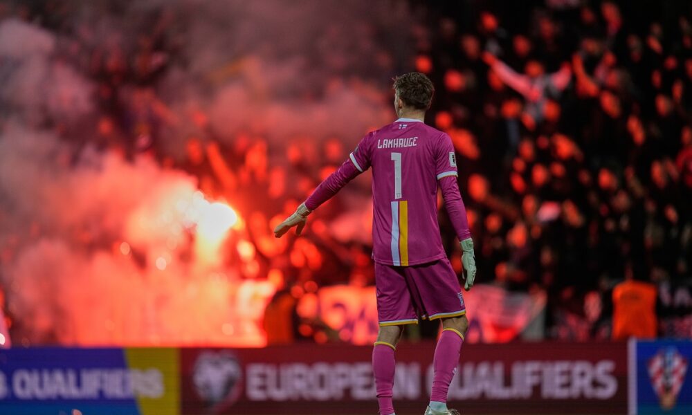 Croat fans burn flares during a World Cup 2026 group L qualifying soccer match between Croatia and Faroe Islands in Rijeka, Croatia, Friday, Nov. 14, 2025. (AP Photo/Darko Bandic)