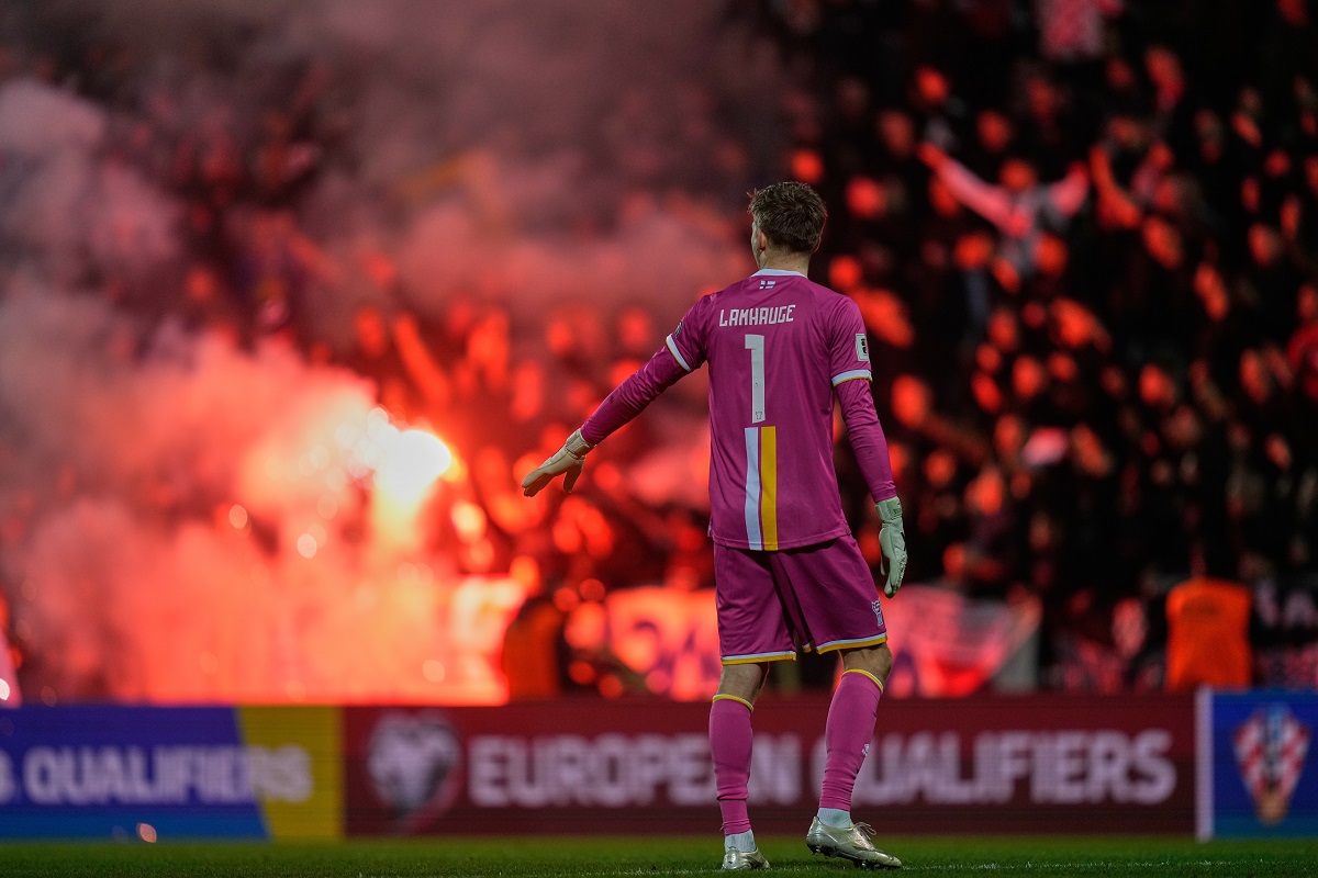 Croat fans burn flares during a World Cup 2026 group L qualifying soccer match between Croatia and Faroe Islands in Rijeka, Croatia, Friday, Nov. 14, 2025. (AP Photo/Darko Bandic)