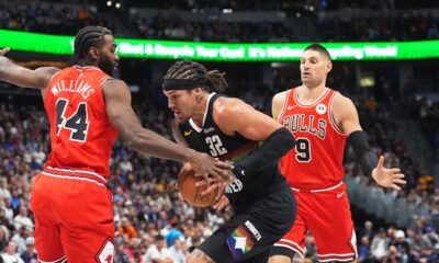 Denver Nuggets forward Aaron Gordon, center, drives to the basket between Chicago Bulls forward Patrick Williams, left, and center Nikola Vučević, right, in the first half of an NBA basketball game Monday, Nov. 17, 2025, in Denver. (AP Photo/David Zalubowski)