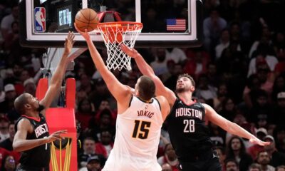 Houston Rockets forward Kevin Durant, left, and Alperen Sengun (28) defend the basket against Denver Nuggets center Nikola Jokic (15) during the second half of an NBA Cup basketball game, Friday, Nov. 21, 2025, in Houston. (AP Photo/Karen Warren)