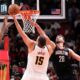 Houston Rockets forward Kevin Durant, left, and Alperen Sengun (28) defend the basket against Denver Nuggets center Nikola Jokic (15) during the second half of an NBA Cup basketball game, Friday, Nov. 21, 2025, in Houston. (AP Photo/Karen Warren)