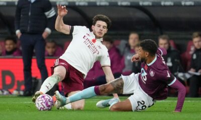 Arsenal's Declan Rice, left, challenges for the ball with Burnley's Josh Laurent during the English Premier League soccer match between Burnley and Arsenal in Burnley, England, Saturday, Nov. 1, 2025. (AP Photo/Jon Super)