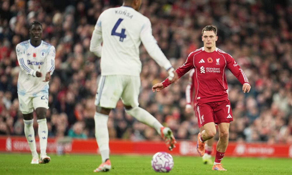 Liverpool's Florian Wirtz, right, and Aston Villa's Ezri Konsa, centre, in action during the English Premier League soccer match between Liverpool and Aston Villa in Liverpool, England, Saturday, Nov. 1, 2025. (AP Photo/Jon Super)