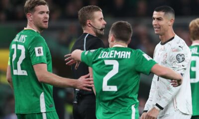 Referee Glenn Nyberg, second left, speaks with Portugal's Cristiano Ronaldo, right during a World Cup 2026 group F qualifying soccer match between Ireland and Portugal in Dublin, Thursday, Nov. 13, 2025. (AP Photo/Peter Morrison)
