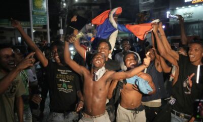 FILE - Fans celebrate Haiti defeating Nicaragua to qualify for the 2026 FIFA World Cup, in Port-au-Prince, Haiti, Nov. 18, 2025. (AP Photo/Odelyn Joseph, File)