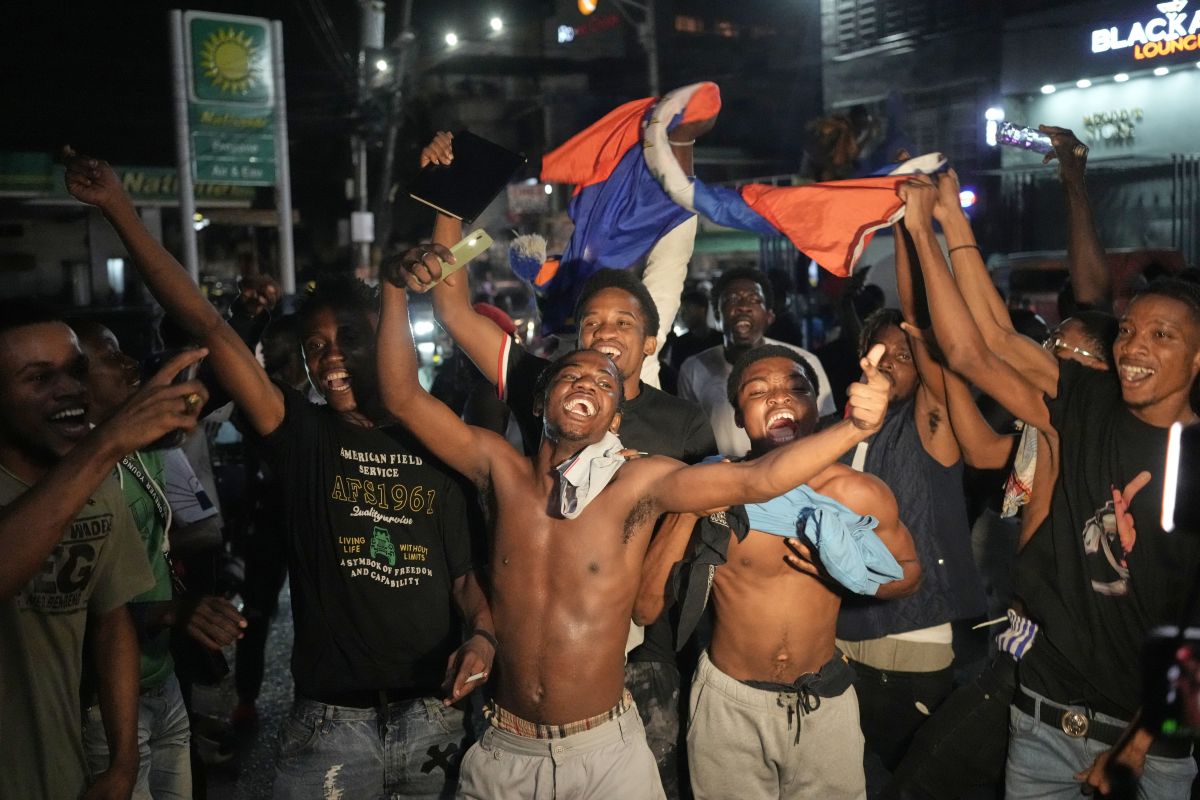 FILE - Fans celebrate Haiti defeating Nicaragua to qualify for the 2026 FIFA World Cup, in Port-au-Prince, Haiti, Nov. 18, 2025. (AP Photo/Odelyn Joseph, File)