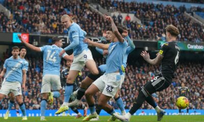 Manchester City's Erling Haaland, centre left, Leeds' Joe Rodon, right, Manchester City's Nico O'Reilly, centre, in action during the English Premier League soccer match between Manchester City and Leeds United in Manchester, England, Saturday, Nov. 29, 2025. (AP Photo/Ian Hodgson)