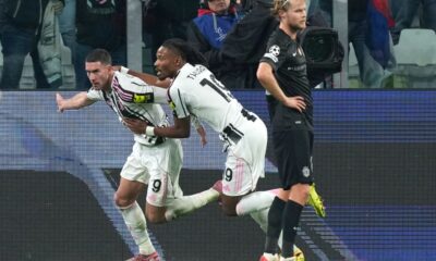 Juventus' Dusan Vlahovic, left, celebrates after scoring his side's first goal during the Champions League opening phase soccer match between Juventus and Sporting CP in Turin, Italy, Tuesday, Nov. 4, 2025. (AP Photo/Antonio Calanni)
